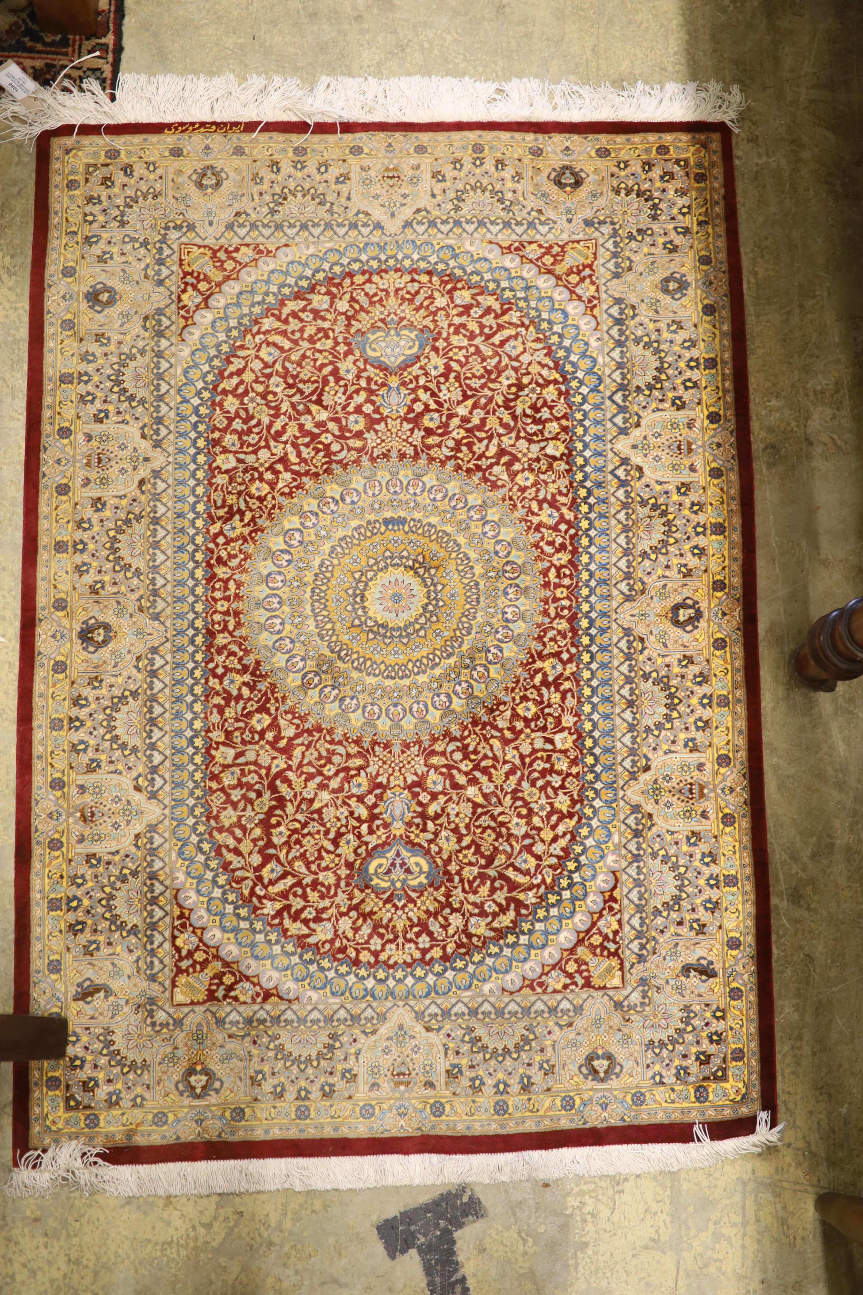 A Persian part red ground silk multi-floral patterned rug, 110 x 80cm